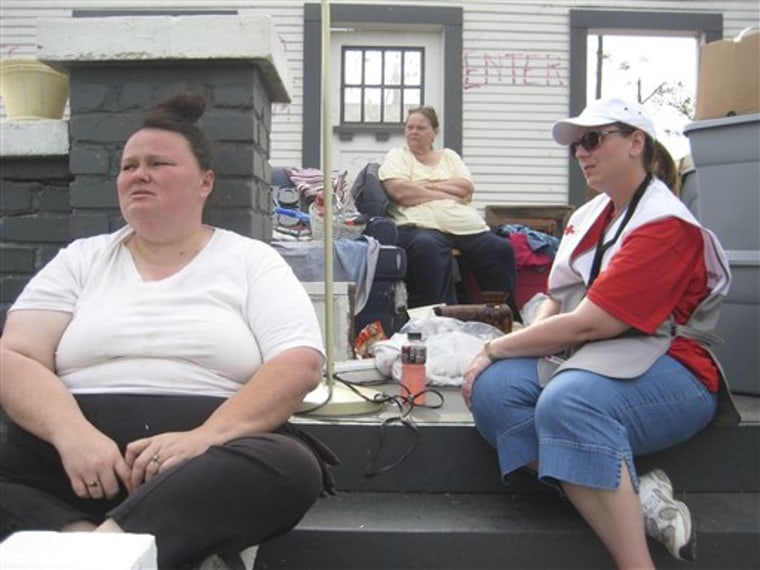 Linda Coordes, at right, a Red Cross social worker from Kelso, Wash., speaks with Lorraine Beasley, center, and her daughter Alice Reeves at Beasley's tornado-stricken home in Pleasant Grove, Ala., May 1. Coordes was part of a Red Cross mental health team that comforted tornado victims.